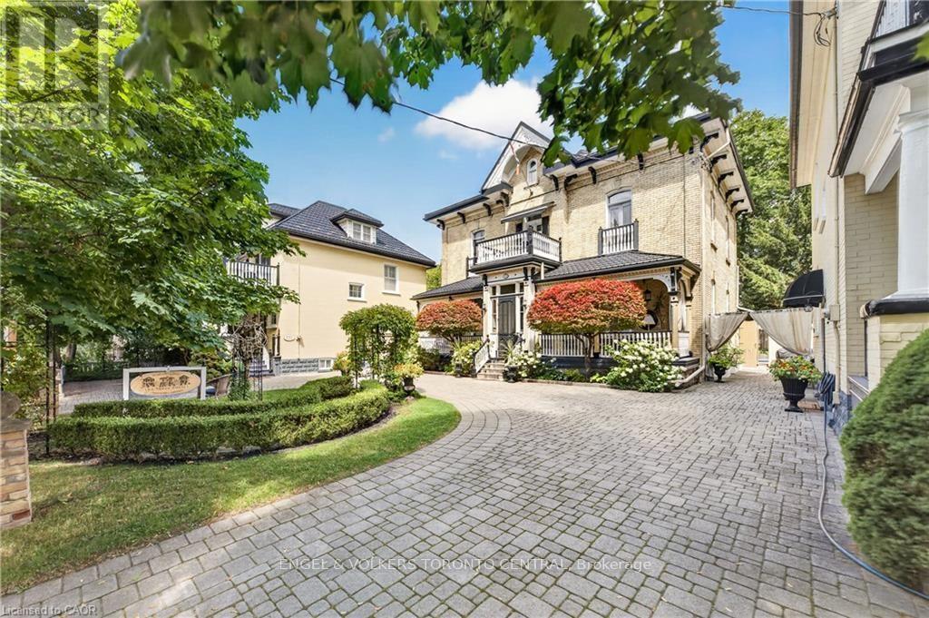 Brick exterior with arched windows & covered porch - 100 Brunswick Street, Stratford, ON