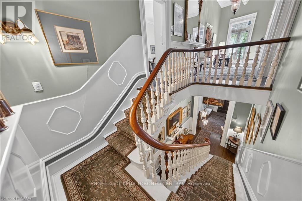 Ornate curved staircase featuring a wood handrail - 100 Brunswick Street, Stratford, ON