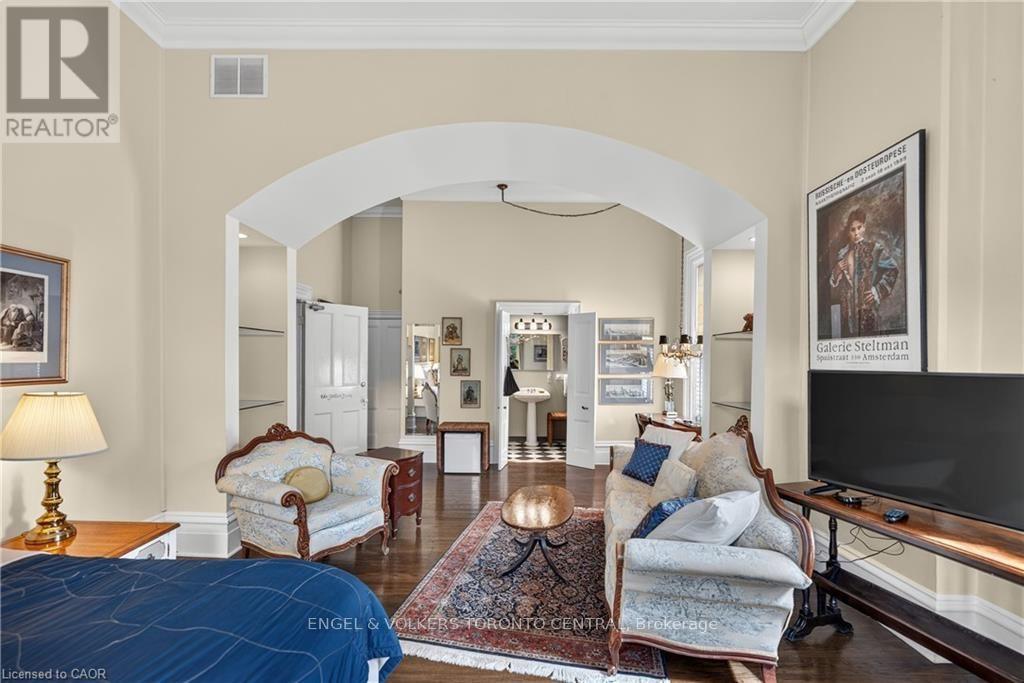 A wide arched doorway, and built-in shelving - 100 Brunswick Street, Stratford, ON