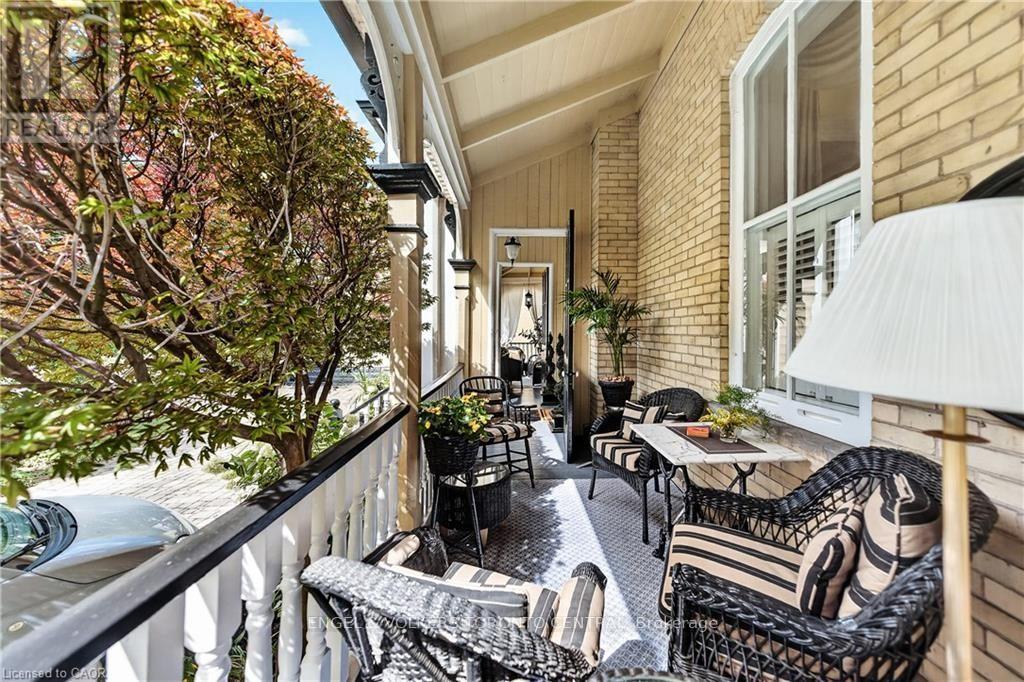 Covered porch with light-colored brick exterior - 100 Brunswick Street, Stratford, ON