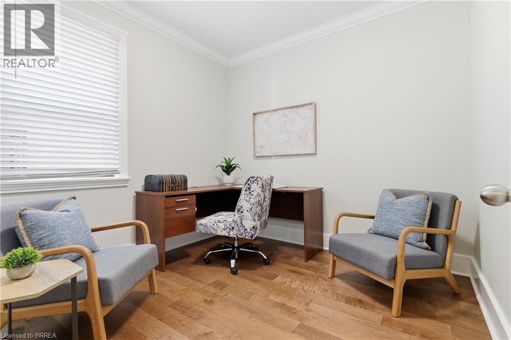 Light-toned walls, crown molding, wood-finish flooring, and a window with blinds - 87 Strathcona Avenue, Brantford, ON