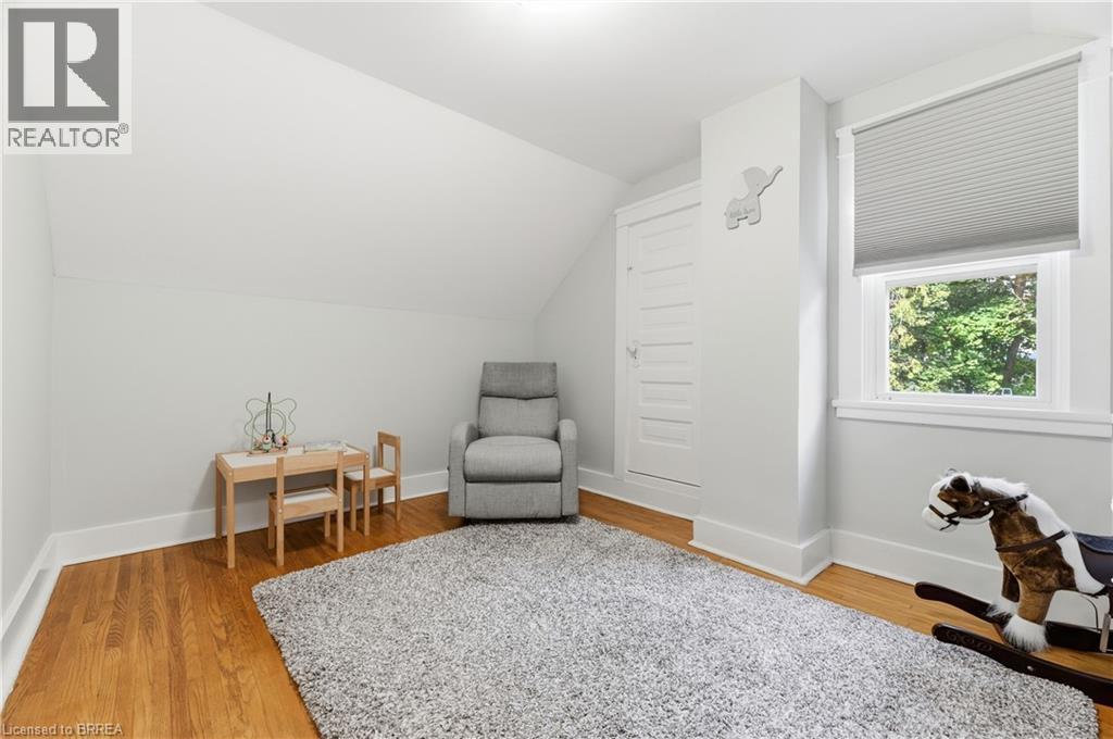 Hardwood flooring, window with cellular shade, recessed lighting, and white trim - 87 Strathcona Avenue, Brantford, ON