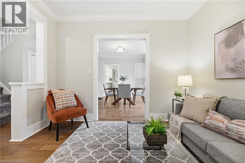 Hardwood flooring with crown molding and white trim details - 87 Strathcona Avenue, Brantford, ON
