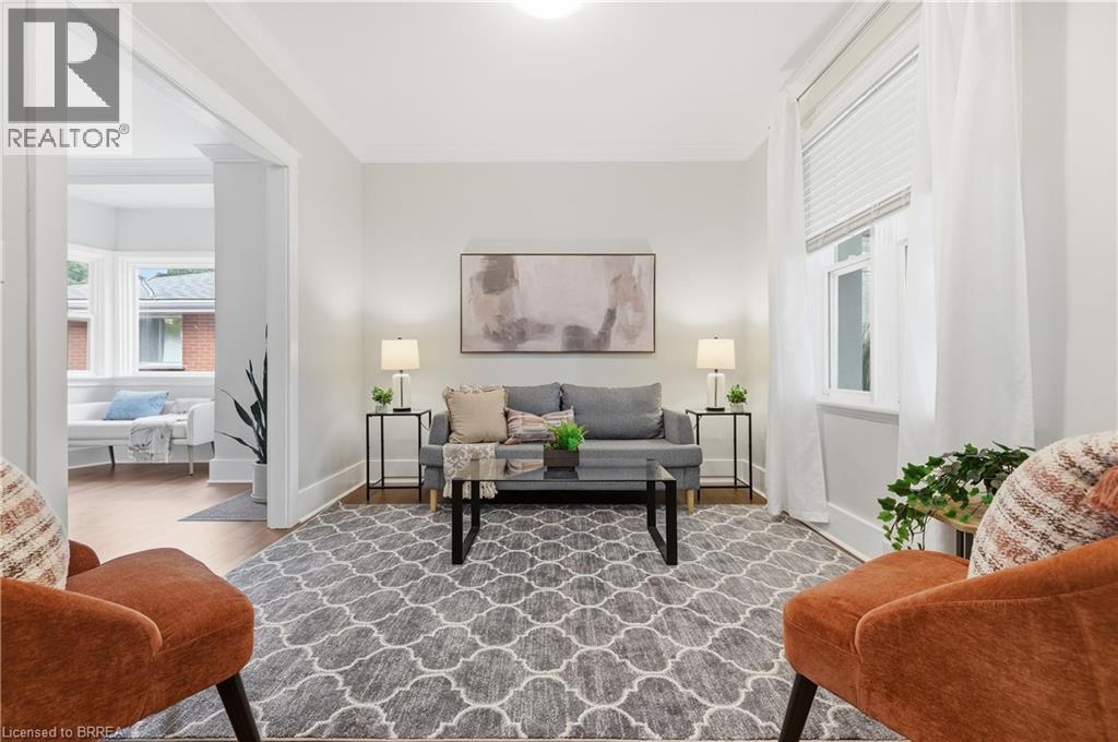 Bright living space with light-toned walls, recessed lighting, and wood-finish flooring - 87 Strathcona Avenue, Brantford, ON
