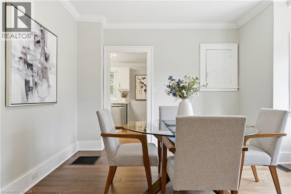 Hardwood flooring, crown molding, white wall paint, and a built-in shuttered window - 87 Strathcona Avenue, Brantford, ON