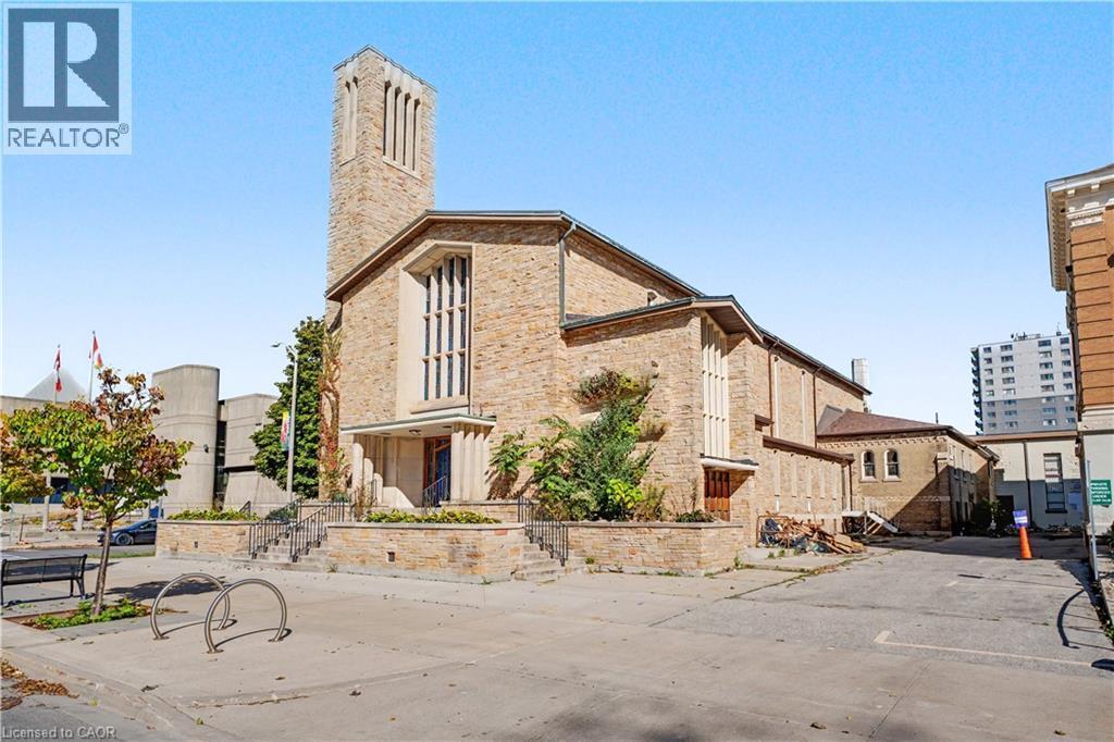 Stone facade with prominent bell tower and multiple large windows - 97 Wellington Street, Brantford, ON