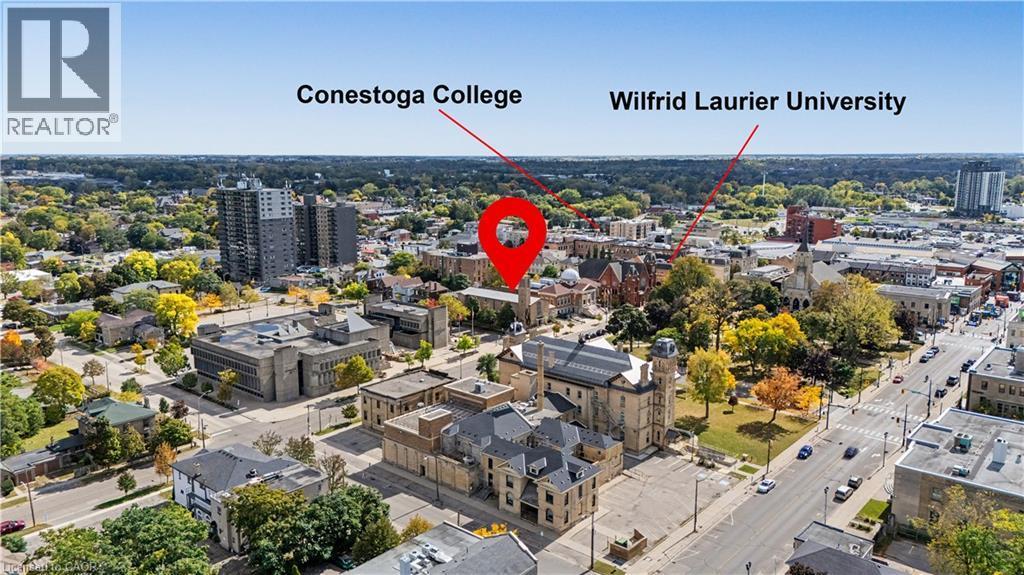 Aerial perspective of the surrounding area, showcasing urban architecture, visible roadways, and mature trees - 97 Wellington Street, Brantford, ON