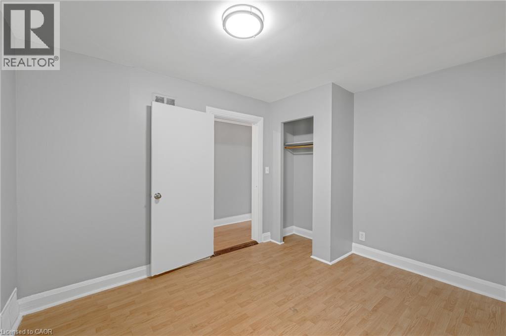 Wood-finish flooring, light gray wall tones, and white trim - 211 Wentworth Street N, Hamilton, ON