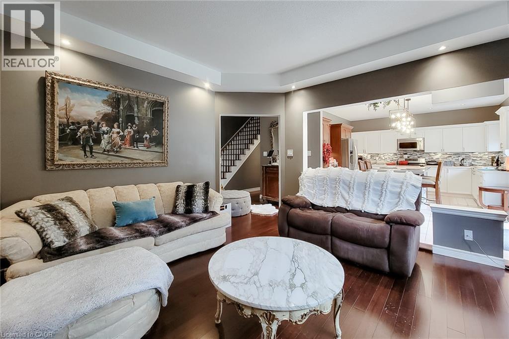 Wood-finish flooring, recessed lighting, and a tray ceiling - 214 Cloverleaf Drive, Ancaster, ON