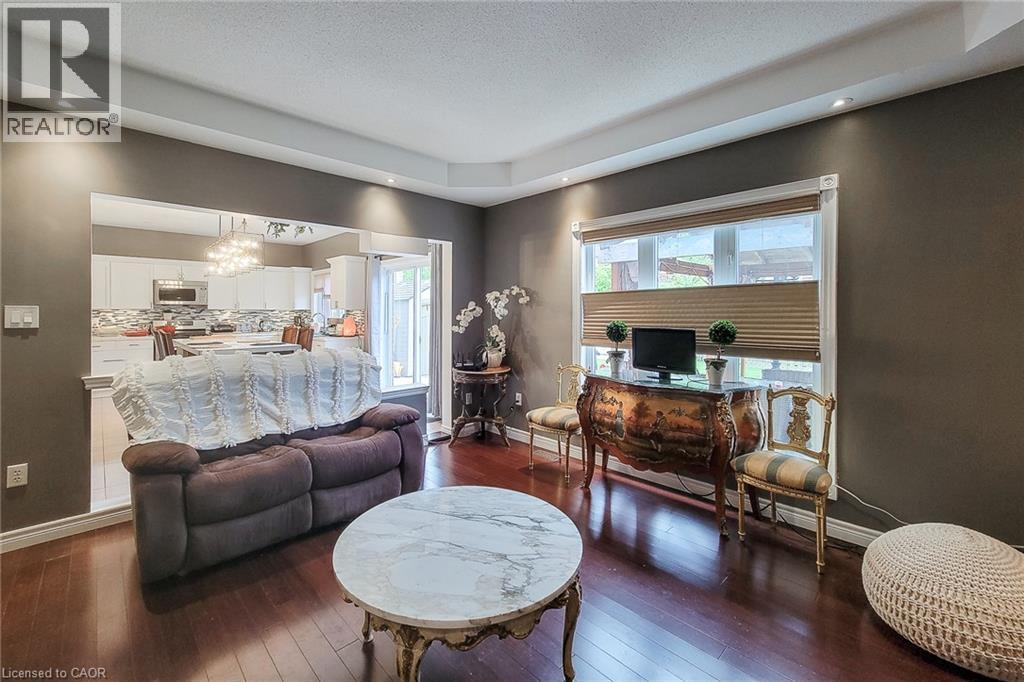 Rich wood-finish flooring complements the neutral wall tones - 214 Cloverleaf Drive, Ancaster, ON