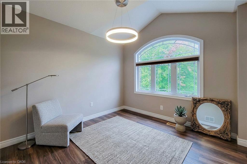 Vaulted ceiling with a contemporary circular pendant light - 214 Cloverleaf Drive, Ancaster, ON