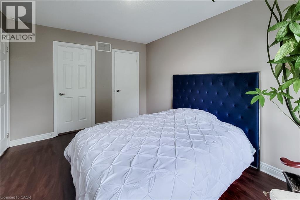 Wood-finish flooring with neutral wall paint and white trim - 214 Cloverleaf Drive, Ancaster, ON