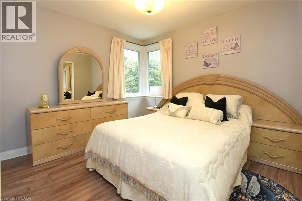 Wood-finish flooring with light-toned walls - 154 Ewen Road, Hamilton, ON