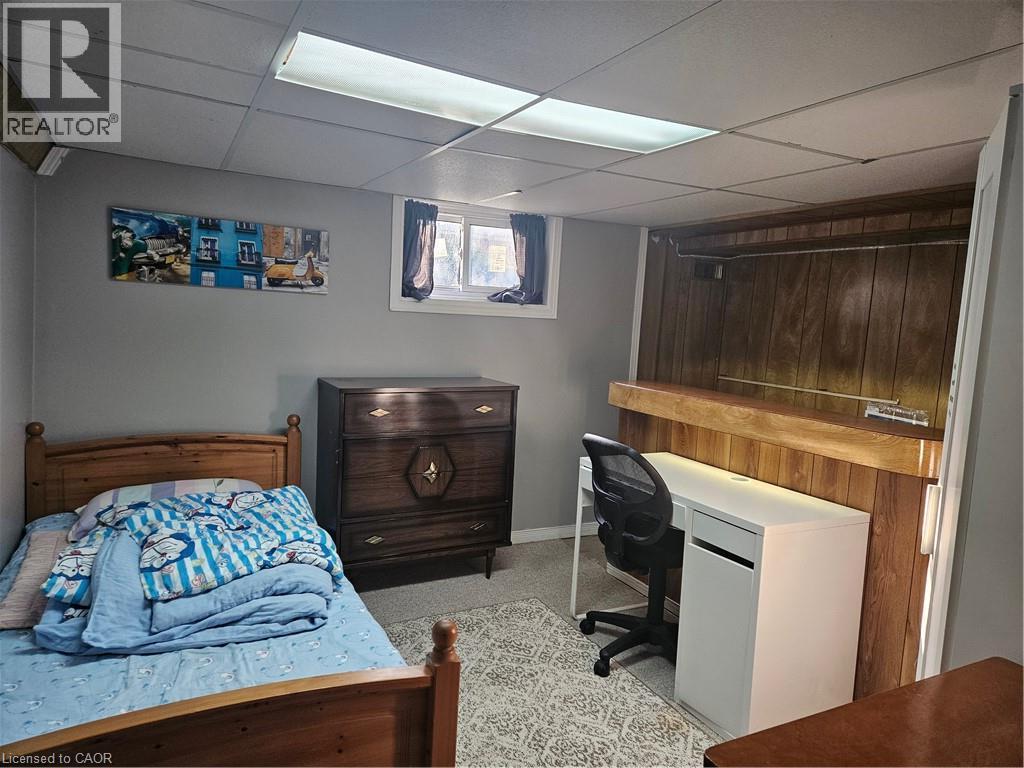 Recessed lighting, drop ceiling, wood paneling, wall-mounted shelving, and window - 154 Ewen Road, Hamilton, ON