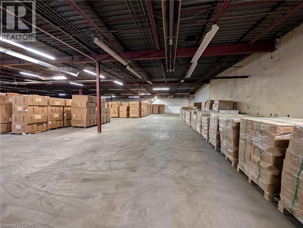 Concrete flooring with exposed ceiling beams and fluorescent lighting - 97 Ardelt Avenue, Kitchener, ON