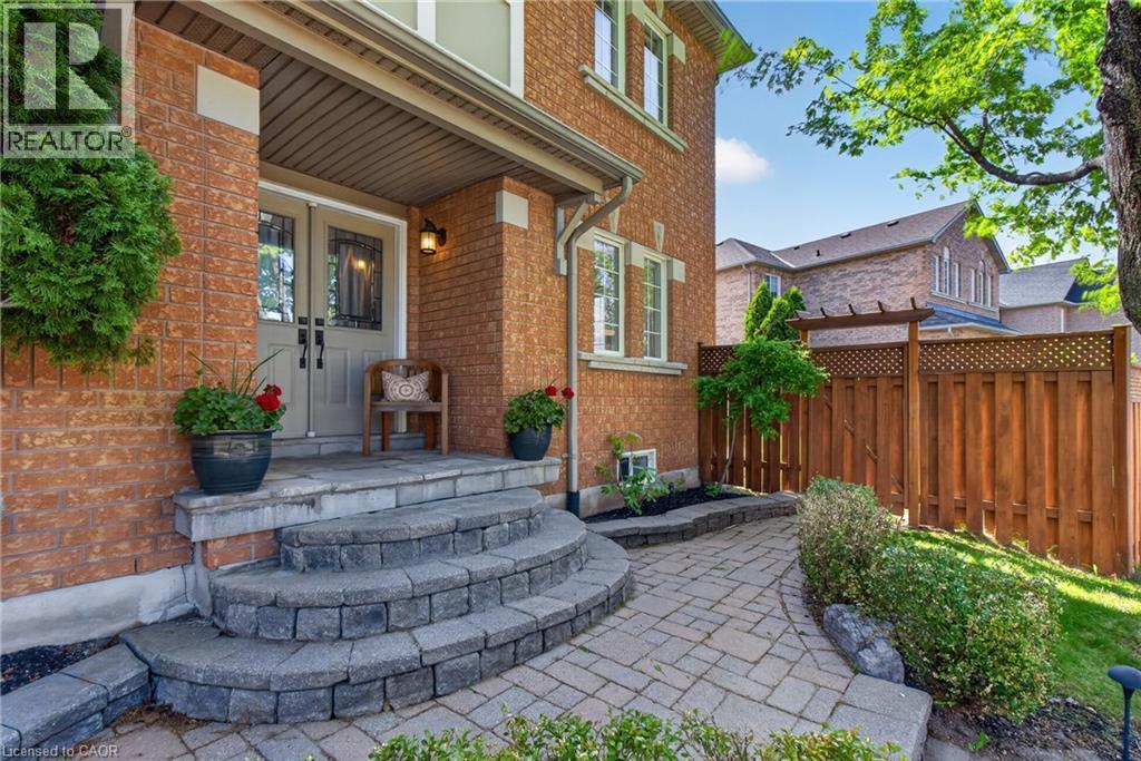 Brick facade residence featuring a covered front entry with double doors - 1347 Brookstar Drive, Oakville, ON