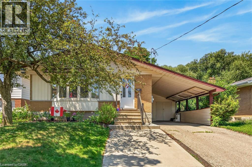 Exterior featuring brick and siding, a covered carport, and a concrete driveway - 33 Ruskview Road Unit# Lower, Kitchener, ON