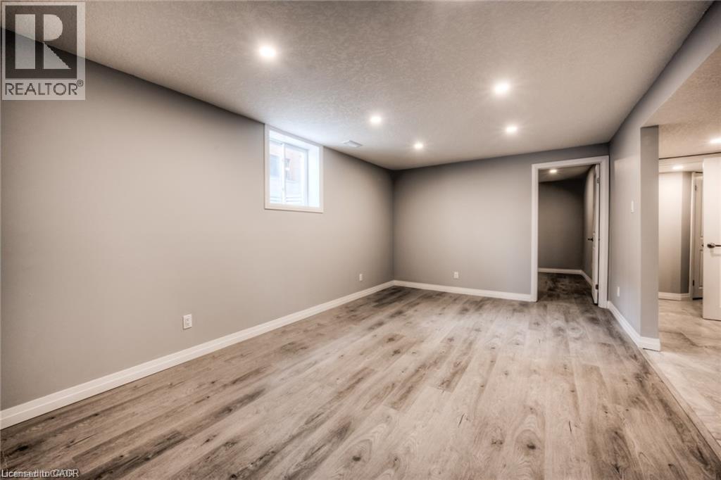 Recessed lighting illuminates wood-finish flooring - 33 Ruskview Road Unit# Lower, Kitchener, ON