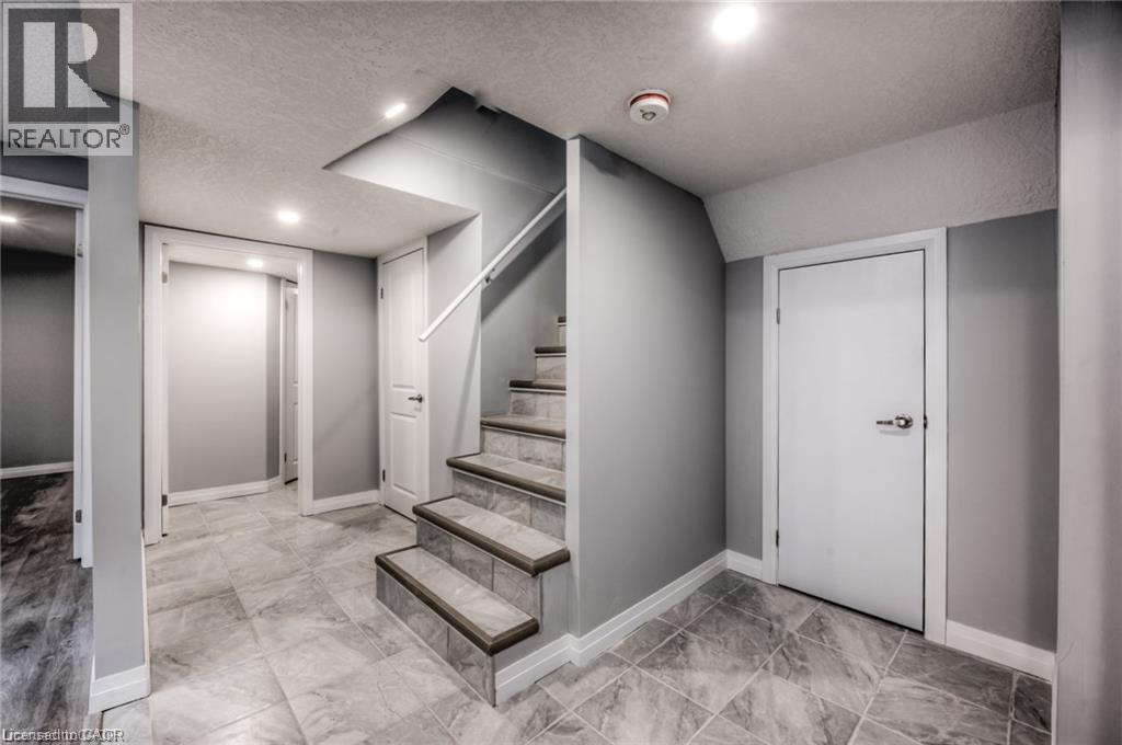Staircase with tile treads and a white handrail - 33 Ruskview Road Unit# Lower, Kitchener, ON