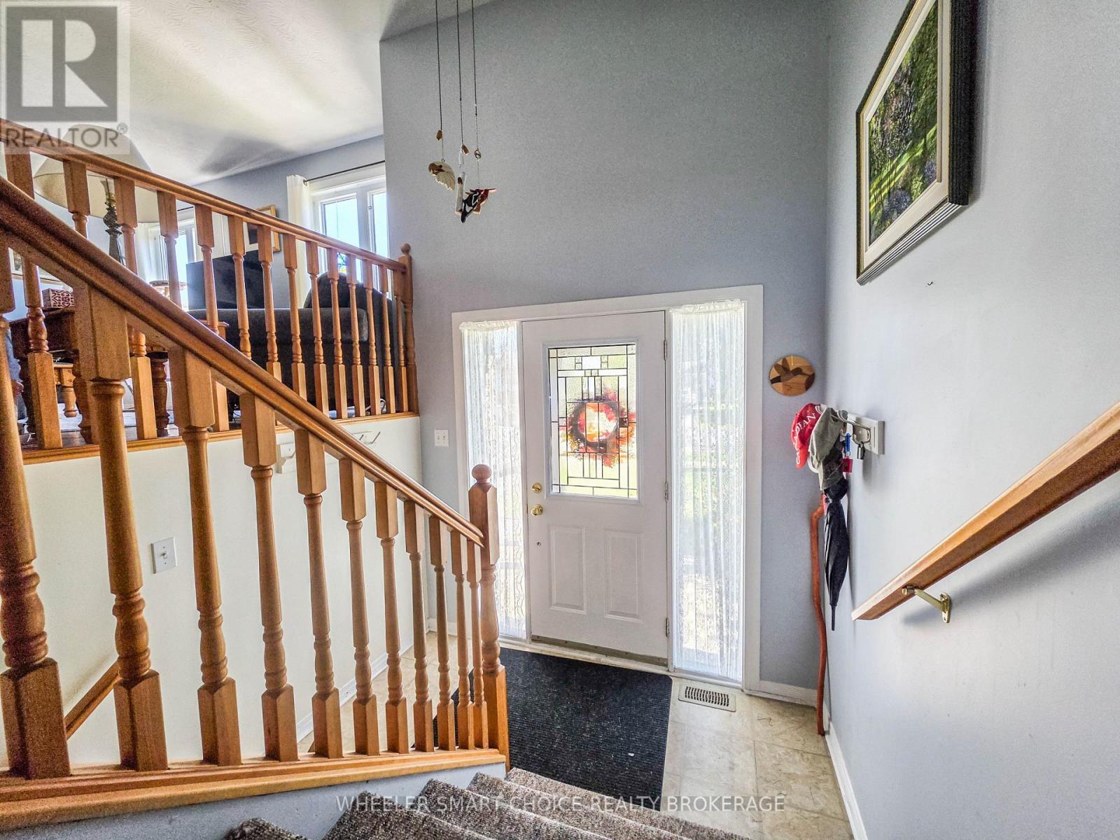 Lovely oak banisters at the front entrance - 78 Maple Street, South Stormont, ON