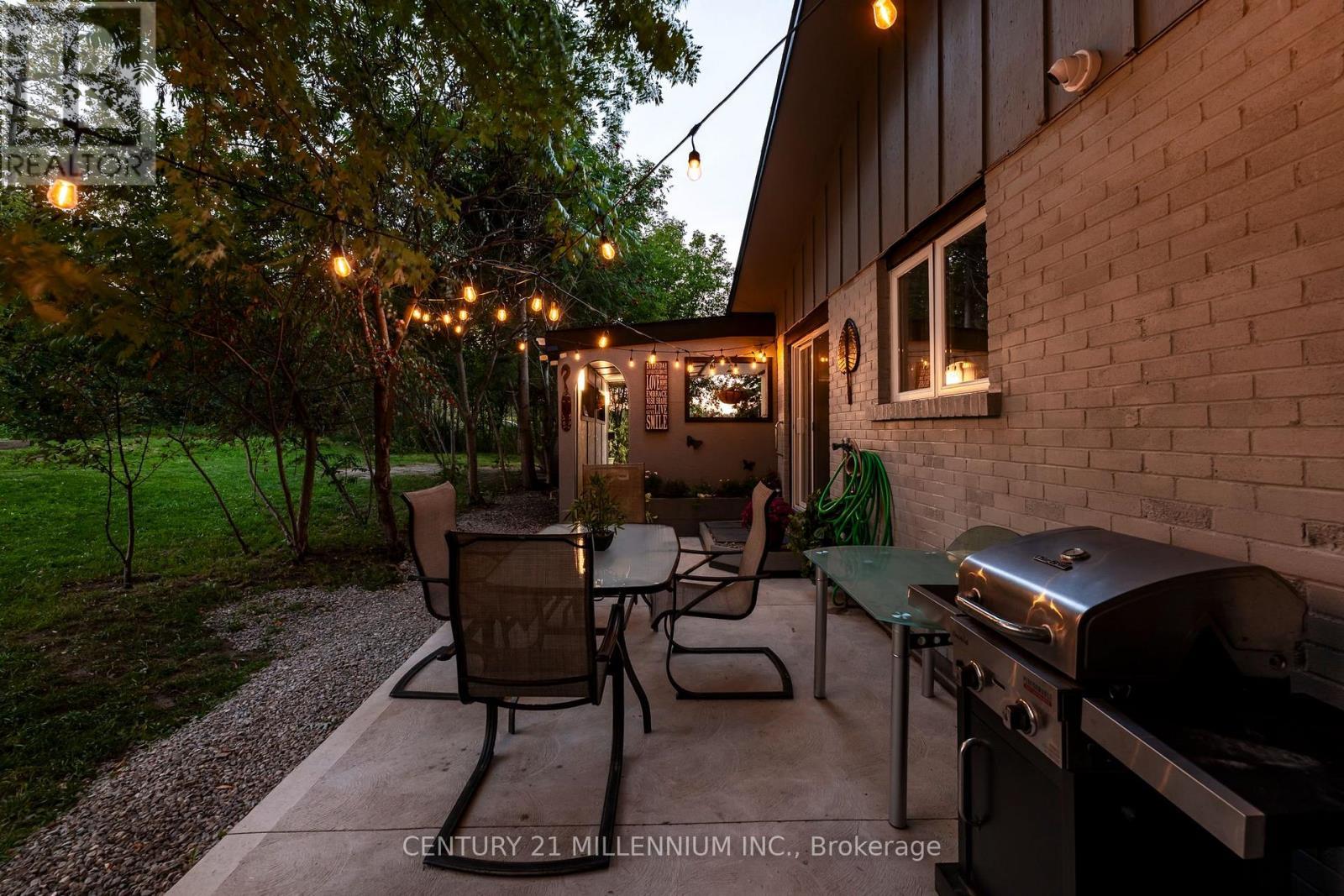 Patio and BBQ area at dusk - 139 Town Line, Orangeville, ON