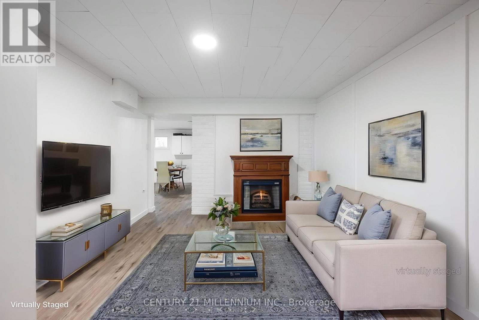 Bsmt living room with fireplace - virtually staged - 139 Town Line, Orangeville, ON