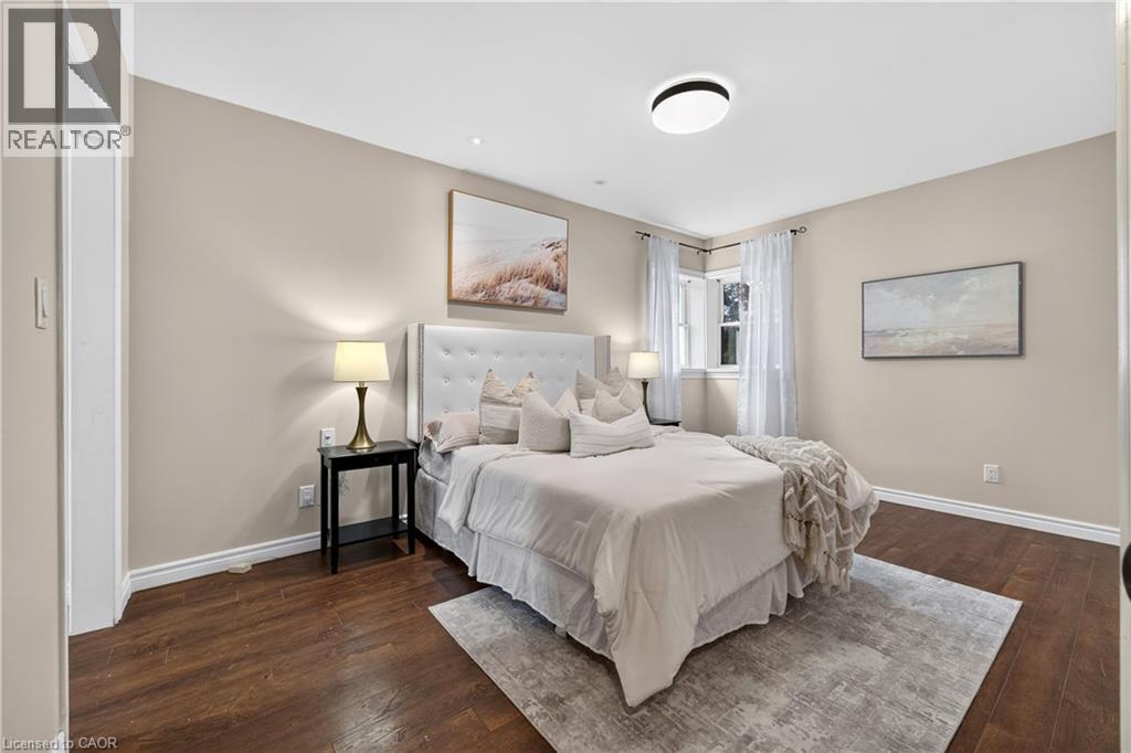 Wood-finish flooring, recessed lighting, and a contemporary ceiling fixture - 176 Avalon Place, Kitchener, ON