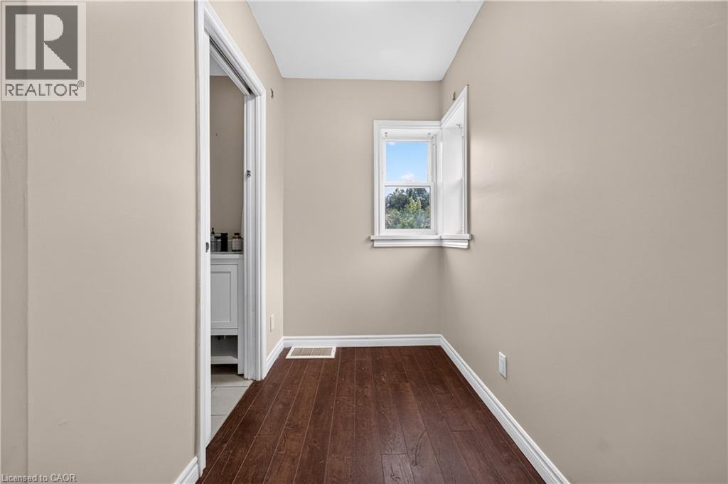 Wood-finish flooring, neutral wall paint, and white trim throughout - 176 Avalon Place, Kitchener, ON