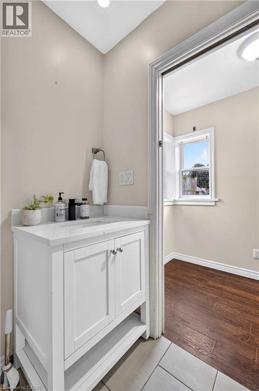 White vanity with a solid surface countertop and undermount sink - 176 Avalon Place, Kitchener, ON