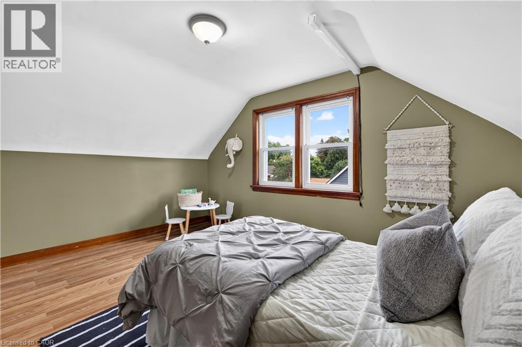 Wood-finish flooring, recessed lighting, and dual windows with wood trim - 176 Avalon Place, Kitchener, ON