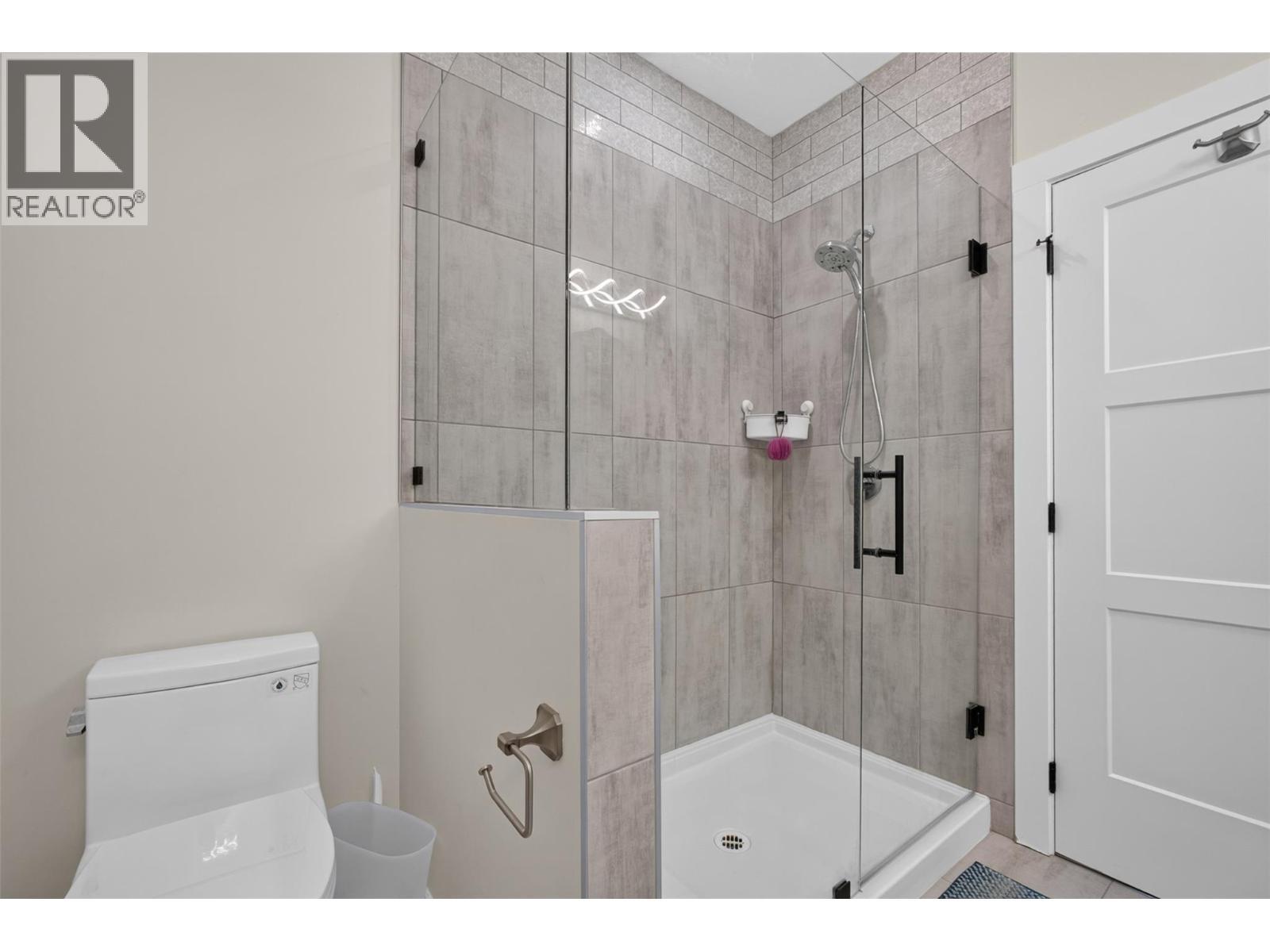 Primary ensuite with a fully tiled glass shower and modern finishes. - 2400 Hawks Boulevard, West Kelowna, BC
