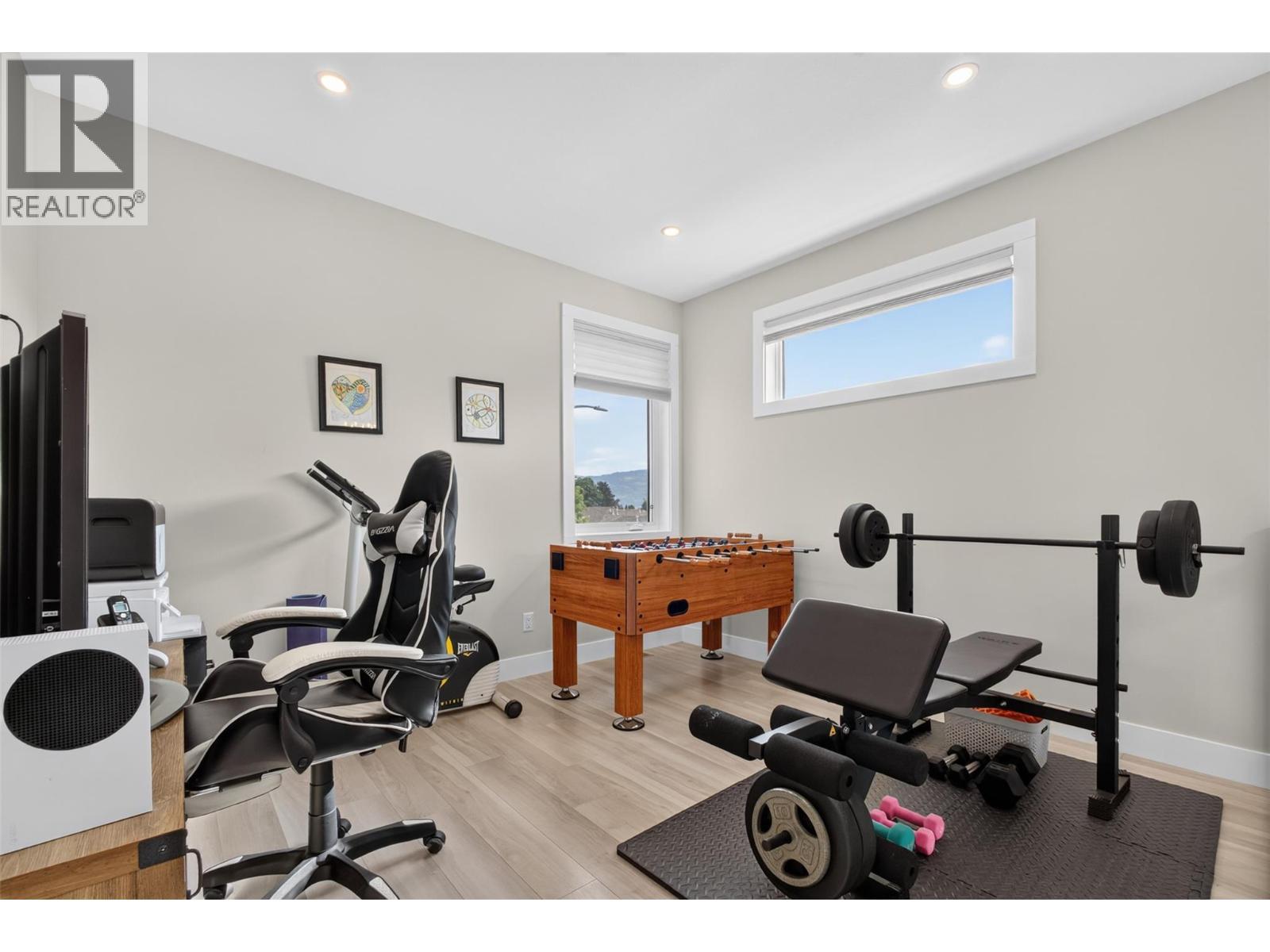 Versatile upstairs bonus space — perfect for a home office, playroom, gym or second living area - 2400 Hawks Boulevard, West Kelowna, BC