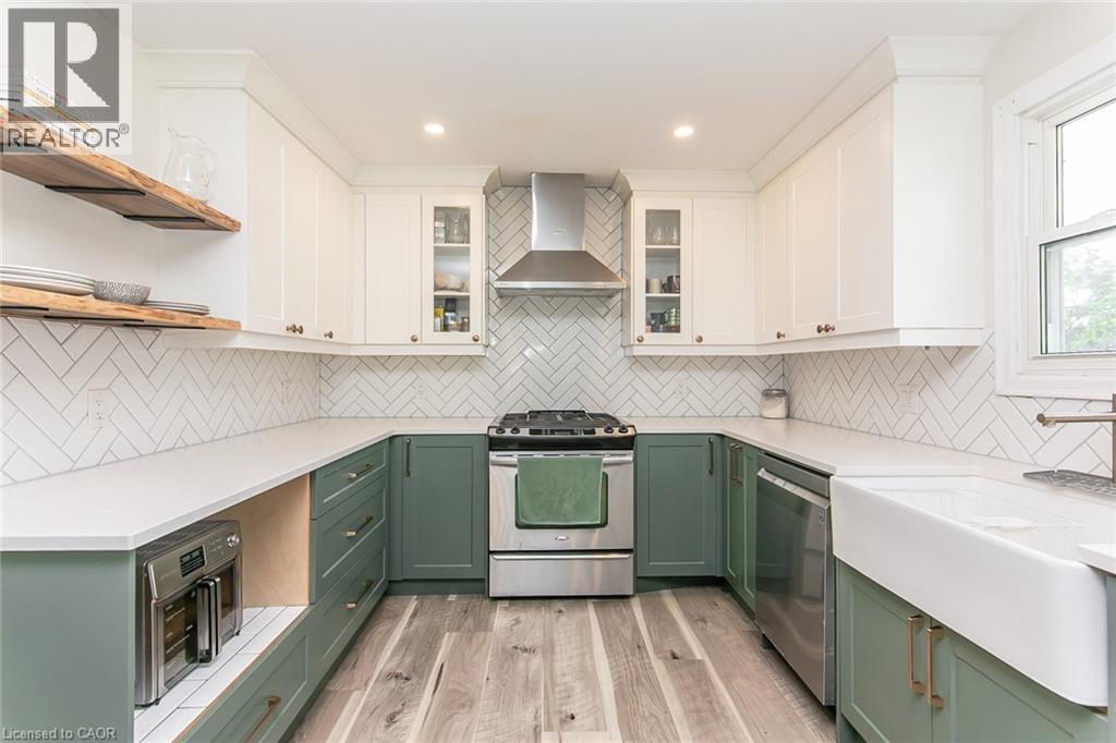 U-shaped kitchen with white upper cabinetry and sage lower cabinetry - 393 Huron Street, New Hamburg, ON