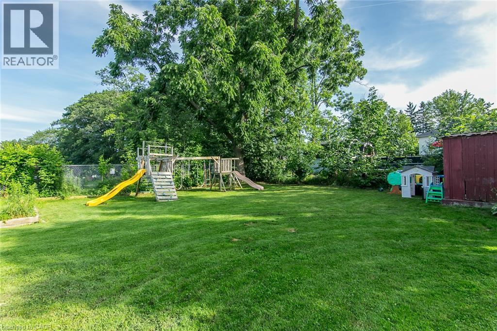 Expansive grassy yard with mature trees - 393 Huron Street, New Hamburg, ON