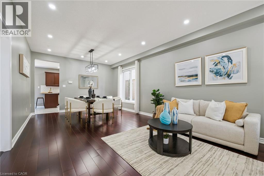 Recessed lighting, wood-finish flooring, and a modern rectangular chandelier - 154 Falconridge Drive, Kitchener, ON
