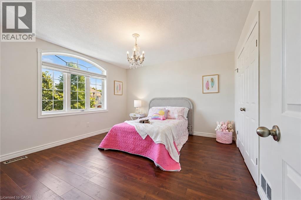 Arch-top window with transoms, wood-finish flooring, recessed lighting, and a crystal chandelier - 154 Falconridge Drive, Kitchener, ON