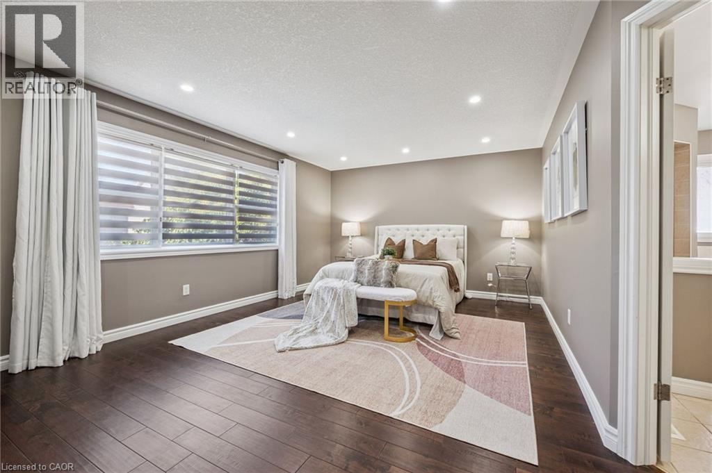 Recessed lighting throughout, wood-finish flooring, and multiple windows with custom blinds - 154 Falconridge Drive, Kitchener, ON
