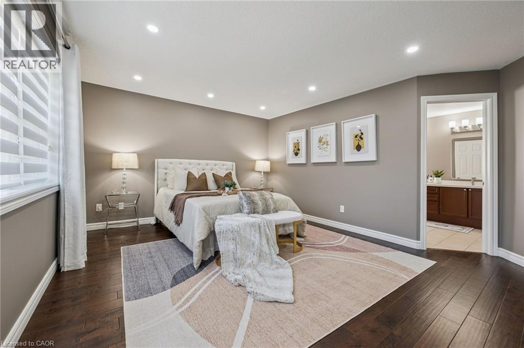 Spacious room with dark wood-finish flooring, recessed lighting, and a window with blinds - 154 Falconridge Drive, Kitchener, ON