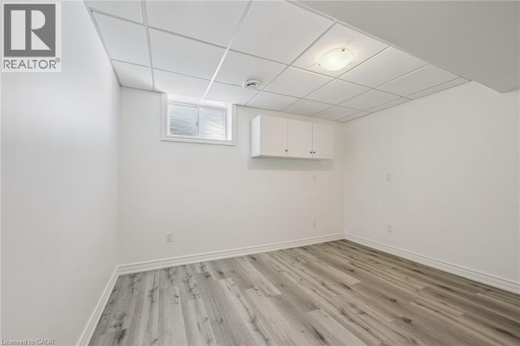 White walls with wood-finish flooring - 154 Falconridge Drive, Kitchener, ON