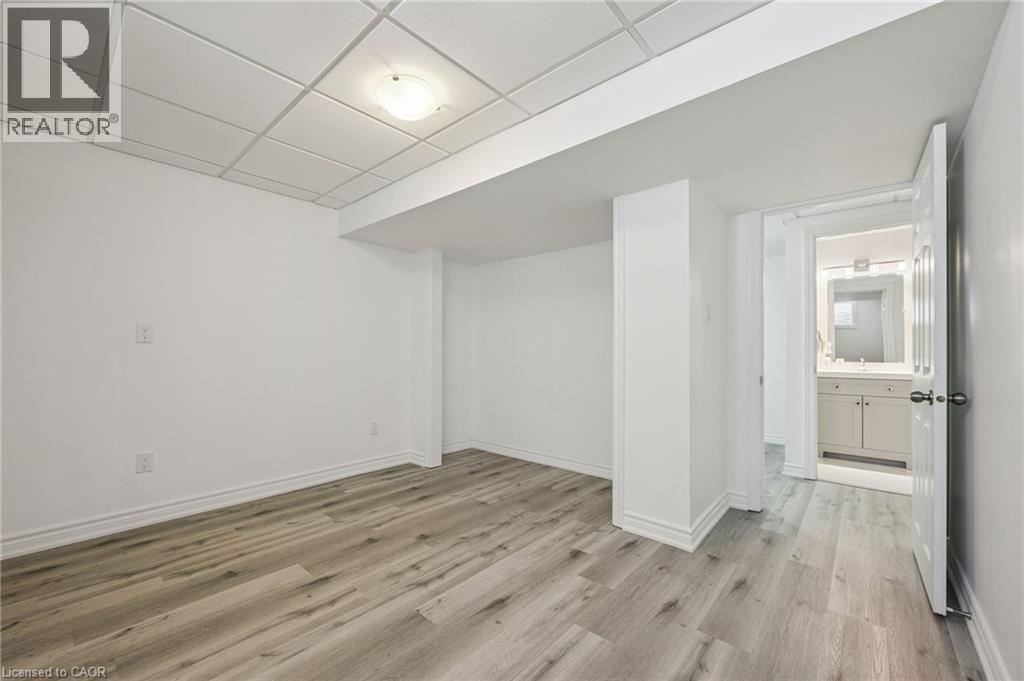 Wood-finish flooring, drop panel ceiling, and recessed lighting - 154 Falconridge Drive, Kitchener, ON