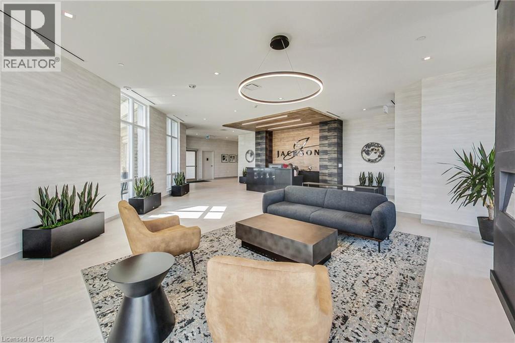 Lobby featuring large-format tile flooring and extensive window lines - 2750 King Street E Unit# 103, Hamilton, ON