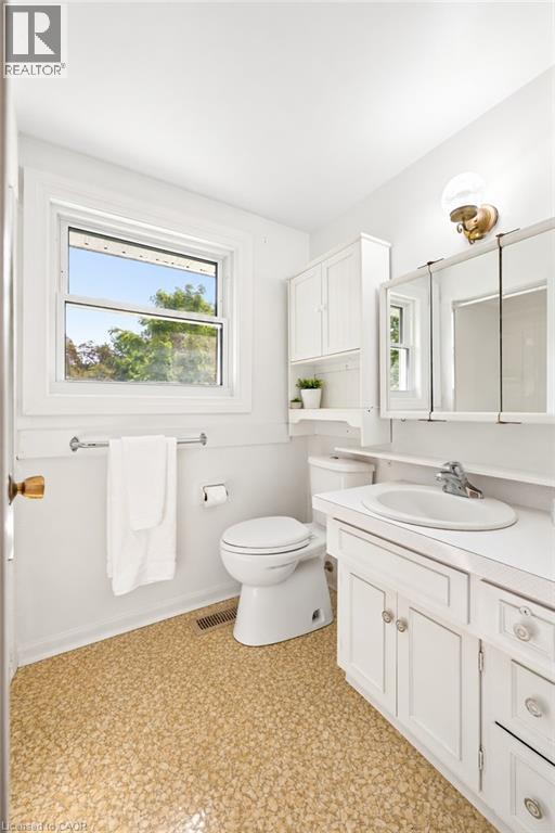 White vanity with integrated sink, chrome faucet, and cabinet storage - 351 Craigleith Drive, Waterloo, ON