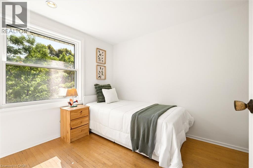 Hardwood flooring, white painted walls, single recessed ceiling light, and a single-hung window - 351 Craigleith Drive, Waterloo, ON