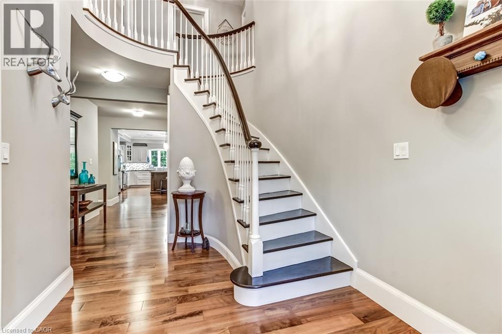 The entrance foyer features the staircase from the original home. - 59 Decou Road, Simcoe, ON