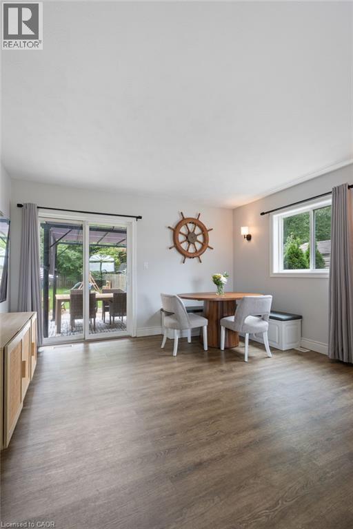 Wood-finish flooring, white walls, and a sliding glass patio door - 53 Hawtrey Road, Delhi, ON