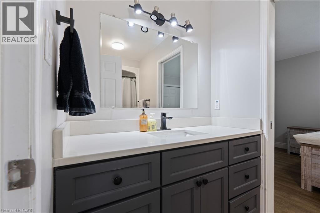 Vanity with a white countertop and an undermount sink - 53 Hawtrey Road, Delhi, ON