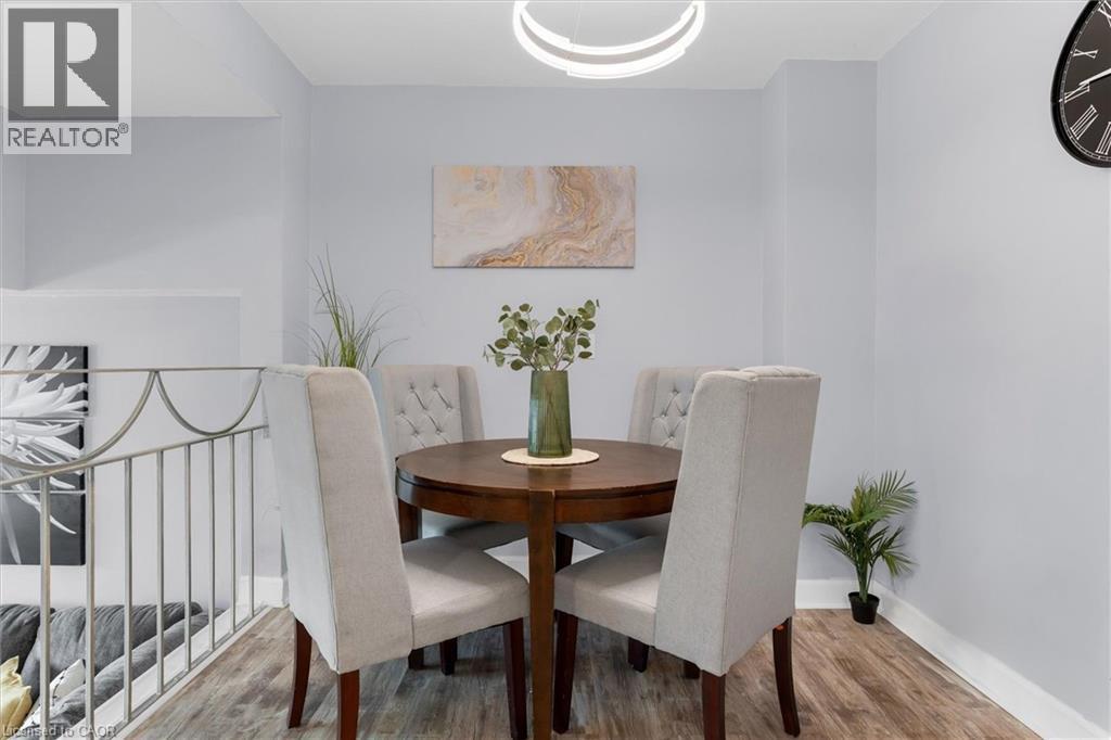 Dining room featuring wood finished floors and baseboards - 5 Viking Court Unit# 301, Grimsby, ON