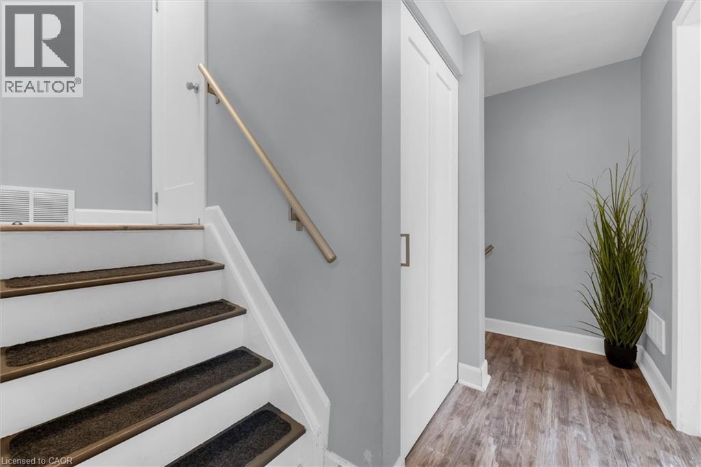 Stairs with wood finished floors and baseboards - 5 Viking Court Unit# 301, Grimsby, ON