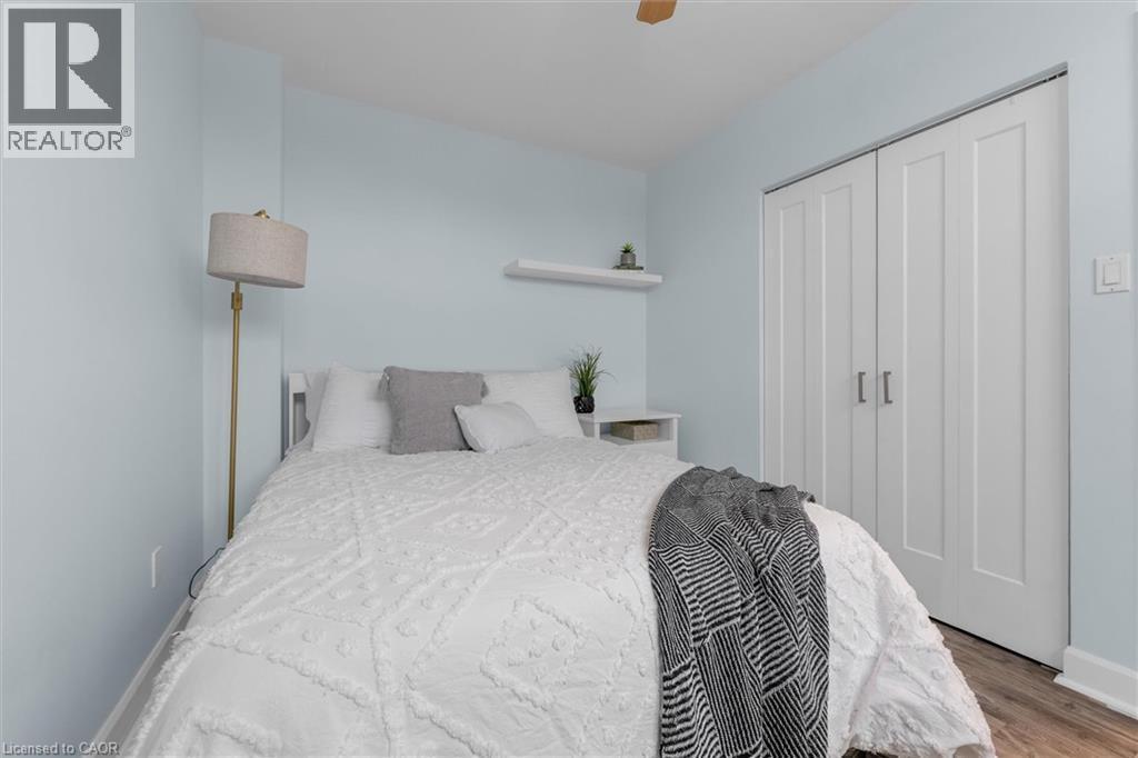 Bedroom featuring a closet, ceiling fan, and wood finished floors - 5 Viking Court Unit# 301, Grimsby, ON