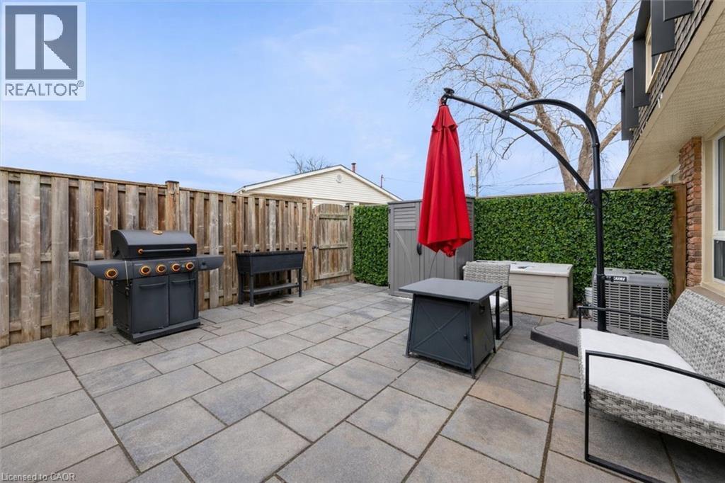 Fenced backyard with a patio area and a grill - 5 Viking Court Unit# 301, Grimsby, ON